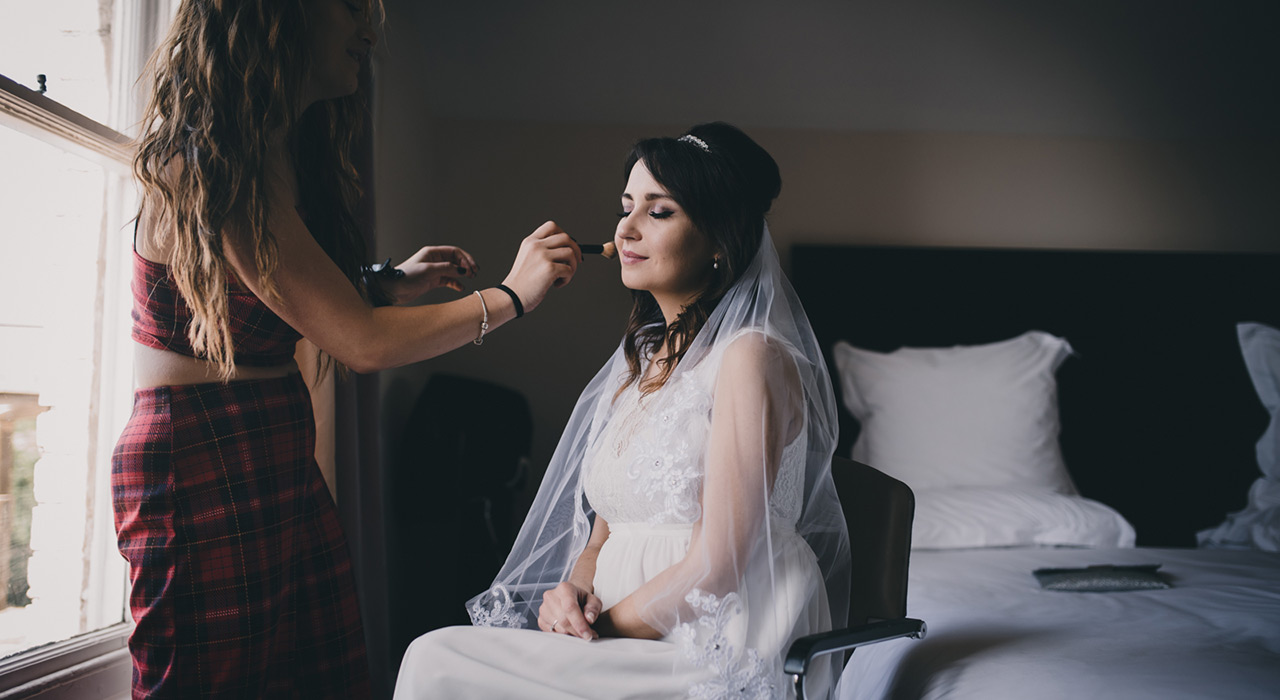 Bride having make-up applied